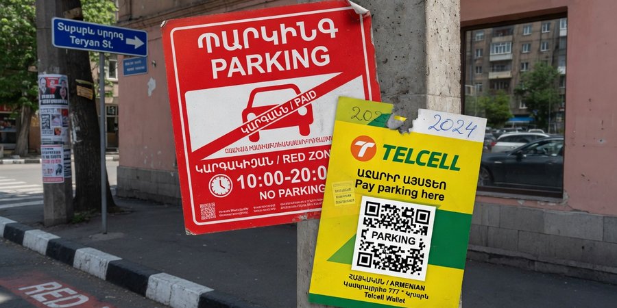 Red-line parking and Telcell payment sticker on a street in central Yerevan