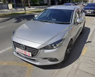 Frontvisning av en leiebil Mazda Axela i Limassol, Kypros ✓ Bil #2050. ✓ Automatisk TM ✓ 0 anmeldelser.