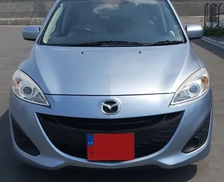 Frontvisning av en leiebil Mazda Premacy på Pafos lufthavn, Kypros ✓ Bil #5029. ✓ Automatisk TM ✓ 0 anmeldelser.