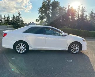 Toyota Camry 2014 car hire in Georgia, featuring ✓ Hybrid fuel and 230 horsepower ➤ Starting from 100 GEL per day.