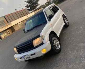 Mitsubishi Pajero Io 2005 car hire in Georgia, featuring ✓ Petrol fuel and 210 horsepower ➤ Starting from 90 GEL per day.