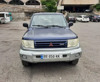 Front view of a rental Mitsubishi Pajero Io in Tbilisi, Georgia ✓ Car #6695. ✓ Automatic TM ✓ 0 reviews.