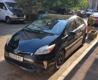 Sprednji pogled najetega avtomobila Toyota Prius v v Tbilisiju, Georgia ✓ Avtomobil #7185. ✓ Menjalnik Samodejno TM ✓ Mnenja 2.