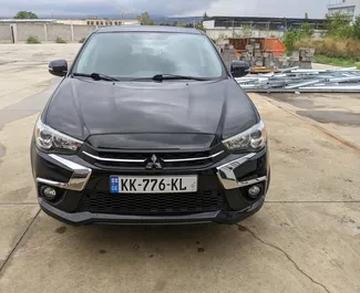 Sprednji pogled najetega avtomobila Mitsubishi Outlander Sport v v Tbilisiju, Georgia ✓ Avtomobil #7905. ✓ Menjalnik Samodejno TM ✓ Mnenja 0.