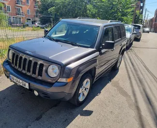 Front view of a rental Jeep Patriot in Tbilisi, Georgia ✓ Car #7950. ✓ Automatic TM ✓ 0 reviews.