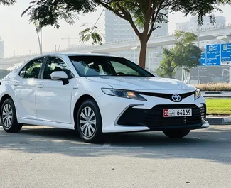 Toyota Camry 2024 car hire in the UAE, featuring ✓ Hybrid fuel and 170 horsepower ➤ Starting from 125 AED per day.