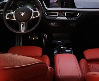 BMW 120i 2021 car hire in the UAE, featuring ✓ Petrol fuel and 180 horsepower ➤ Starting from 280 AED per day.