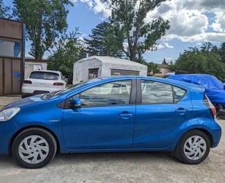 Toyota Prius C 2014 car hire in Georgia, featuring ✓ Hybrid fuel and 99 horsepower ➤ Starting from 75 GEL per day.