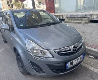 Front view of a rental Opel Corsa at Tirana airport, Albania ✓ Car #9416. ✓ Manual TM ✓ 0 reviews.