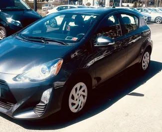 Front view of a rental Toyota Prius C at Tbilisi Airport, Georgia ✓ Car #9558. ✓ Automatic TM ✓ 0 reviews.