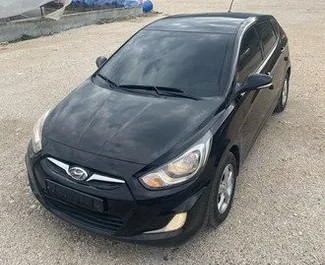 Frontvisning av en leiebil Hyundai Accent Blue i Tirana, Albania ✓ Bil #9679. ✓ Automatisk TM ✓ 1 anmeldelser.