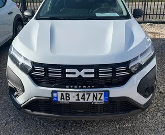 Front view of a rental Dacia Sandero Stepway at Tirana airport, Albania ✓ Car #10102. ✓ Manual TM ✓ 0 reviews.