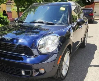 Front view of a rental Mini Countryman Cooper S at Tirana airport, Albania ✓ Car #9991. ✓ Manual TM ✓ 0 reviews.