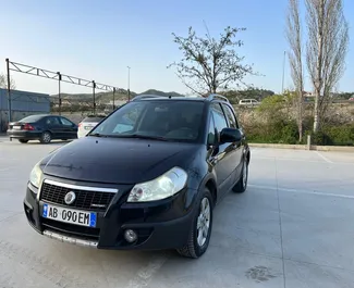 Frontvisning av en leiebil Fiat Sedici i Tirana, Albania ✓ Bil #9999. ✓ Manuell TM ✓ 0 anmeldelser.