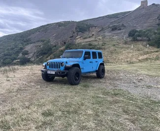 Front view of a rental Jeep Wrangler Rubicon in Tbilisi, Georgia ✓ Car #10528. ✓ Automatic TM ✓ 0 reviews.