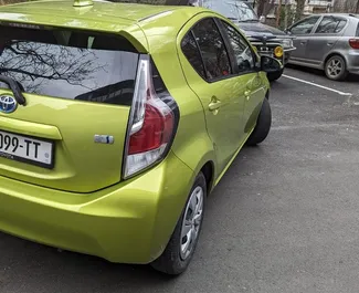 Petrol 1.5L engine of Toyota Prius C 2015 for rental in Tbilisi.