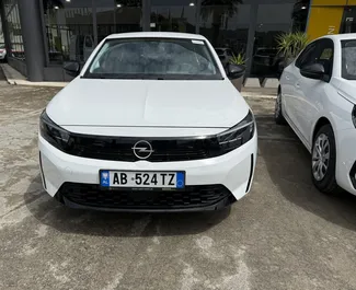 Front view of a rental Opel Corsa at Tirana airport, Albania ✓ Car #13540. ✓ Manual TM ✓ 0 reviews.