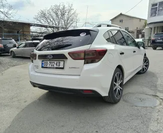 Predný pohľad na prenajaté auto Subaru Impreza v v Tbilisi, Georgia ✓ Auto č. 15206. ✓ Prevodovka Automatické TM ✓ Hodnotenia 0.