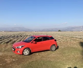 Front view of a rental Hyundai i20 at Podgorica Airport, Montenegro ✓ Car #15721. ✓ Automatic TM ✓ 0 reviews.