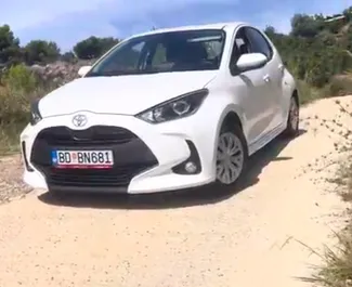 Front view of a rental Toyota Yaris at Podgorica Airport, Montenegro ✓ Car #16207. ✓ Automatic TM ✓ 0 reviews.