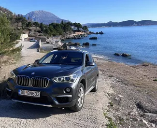 Front view of a rental BMW X1 at Podgorica Airport, Montenegro ✓ Car #16200. ✓ Automatic TM ✓ 0 reviews.
